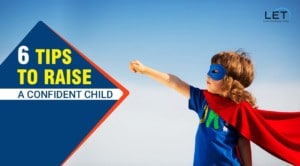 A young boy wearing a superman mask and cape.