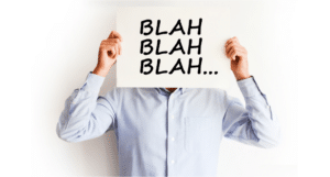 A man holding up a sign that says blah blah blah