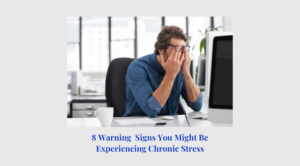 A man sitting at his desk with his hands on the head.