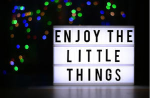 A light box that says " enjoy the little things ".