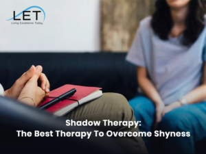 A person sitting on the couch with another person.